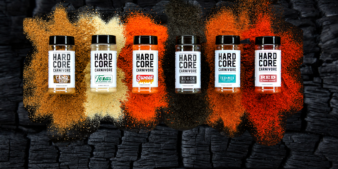 Five bottles of Hardcore Carnivore supplements on a dark charcoal background